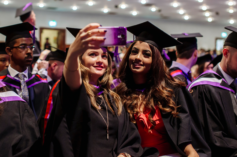 2 graduates taking a selfie